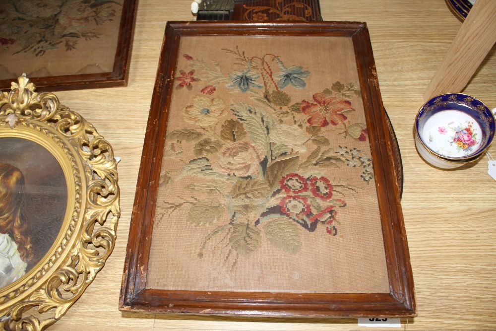 A gilt framed oil portrait of a young lady signed E. Reilly, diameter 22cm, overall 40cm, and two woolwork floral panels, 37 x 26cm